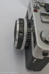 Minolta Hi-Matic F 35mm rangefinder camera showing focus scale and flash guide number