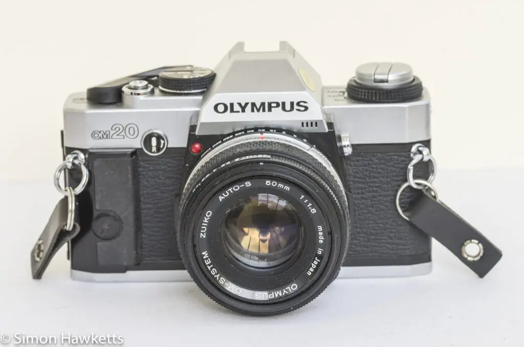 olympus om 20 35mm slr front view with lens cap off