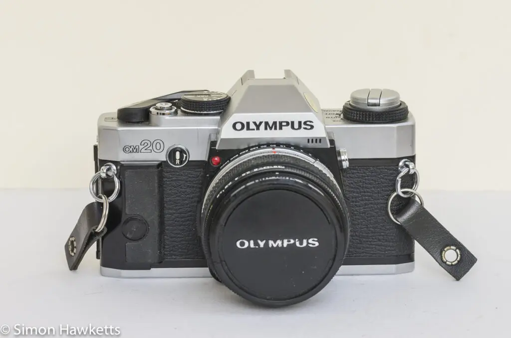 olympus om 20 35mm slr front view with lens cap on
