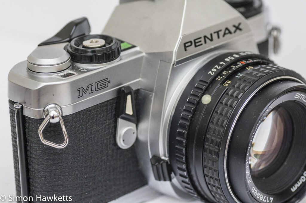 Pentax MG 35mm slr showing self timer and lens release