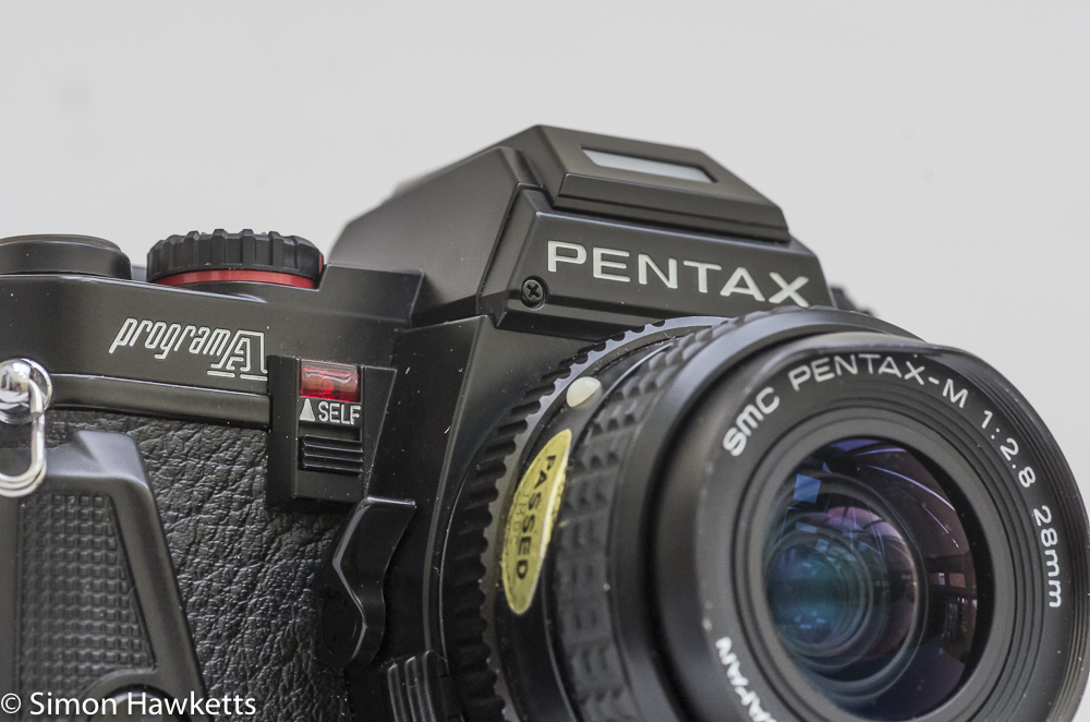 pentax program a 35mm slr camera front view with 28mm smc pentax m f 2 8