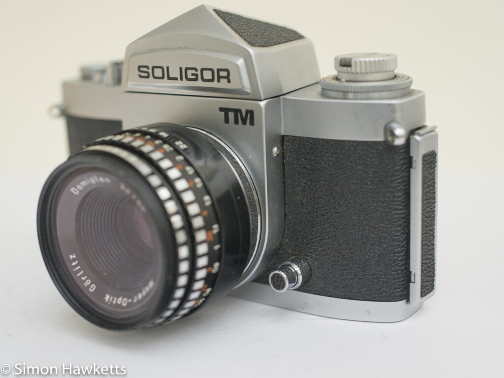 soligor tm 35mm slr camera showing metering button and right side view
