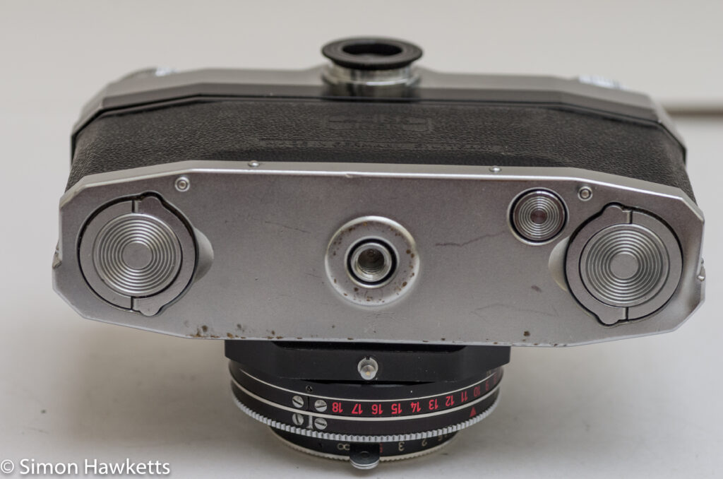 Zeiss Ikon Contaflex alpha - Bottom of camera showing twin cover locks, tripod bush and rewind button