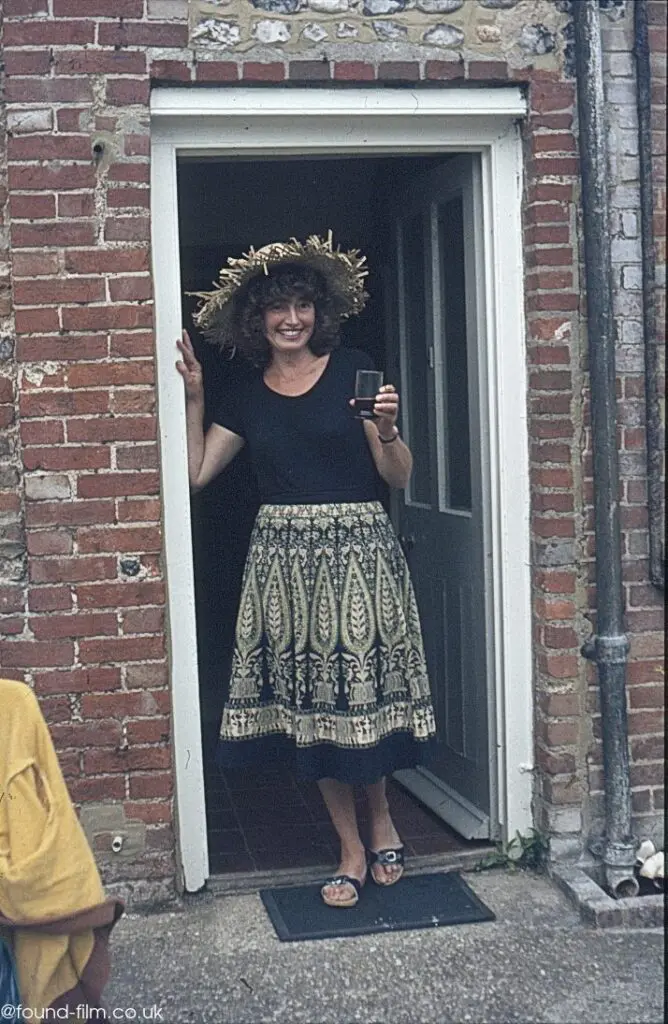 A Woman in a doorway holding a drink - Spring 1981