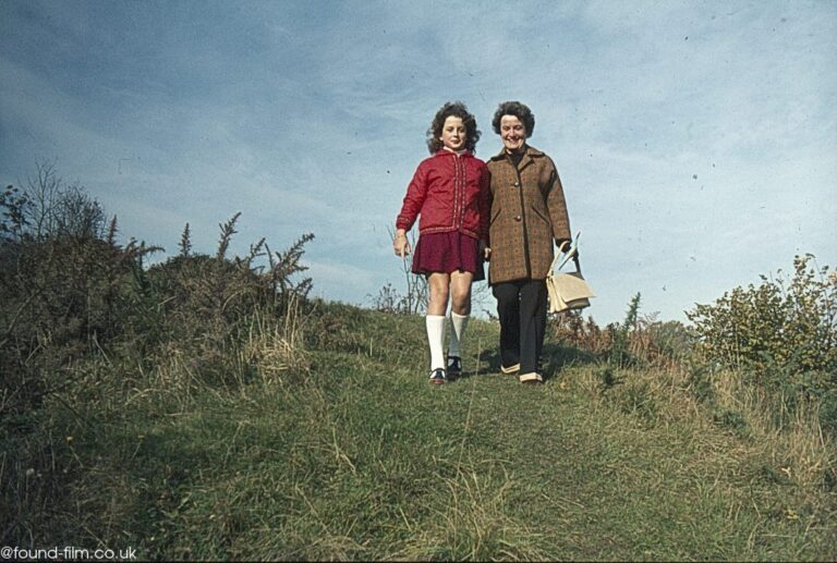 Mother and daughter walking down a hill