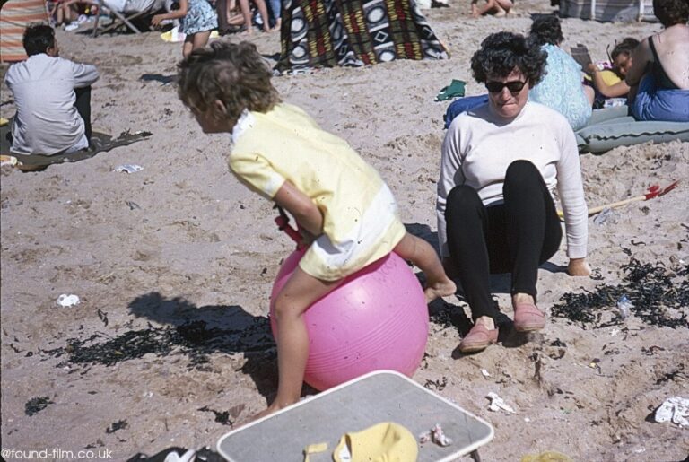 Small child on a bouncer on the beach