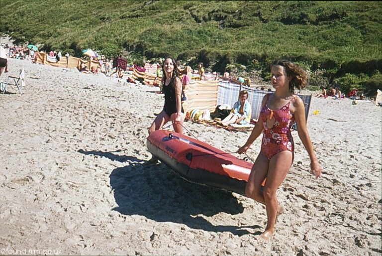 Two girls taking a dinghy to the sea